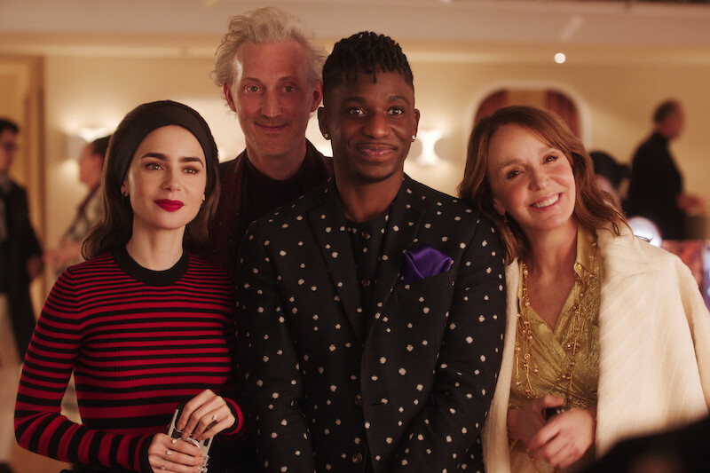 Lily Collins as Emily, Bruno Gouery as Luc, Samuel Arnold as Julien, Philippine Leroy-Beaulieu as Sylvie Grateau gather togehter in an office in Season 4 of 'Emily in Paris'