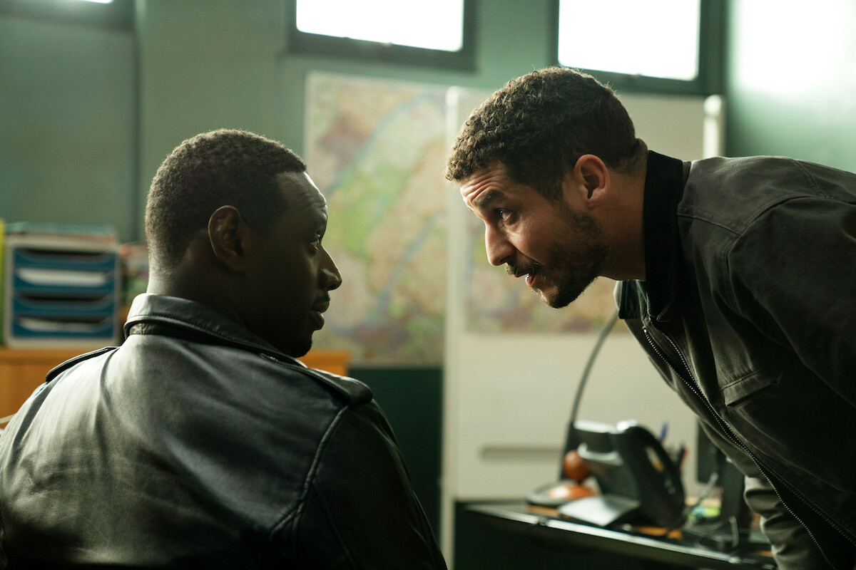 Omar Sy as Assane Lupin and Soufiane Guerrab as Youssef Guedira work together in a police station in Season 3 of ‘Lupin.’