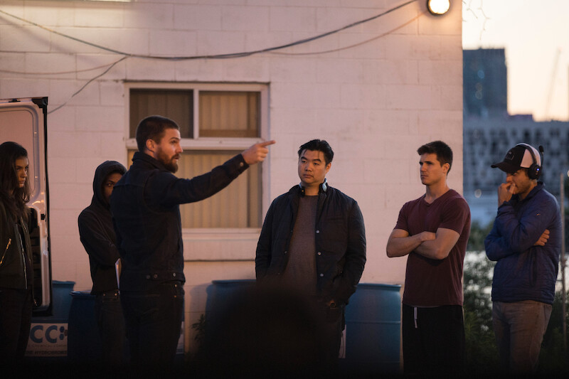 Behind the scenes shot of crew working with Stephen Amell as Garrett and Robbie Amell as Connor Reed in 'Code 8'