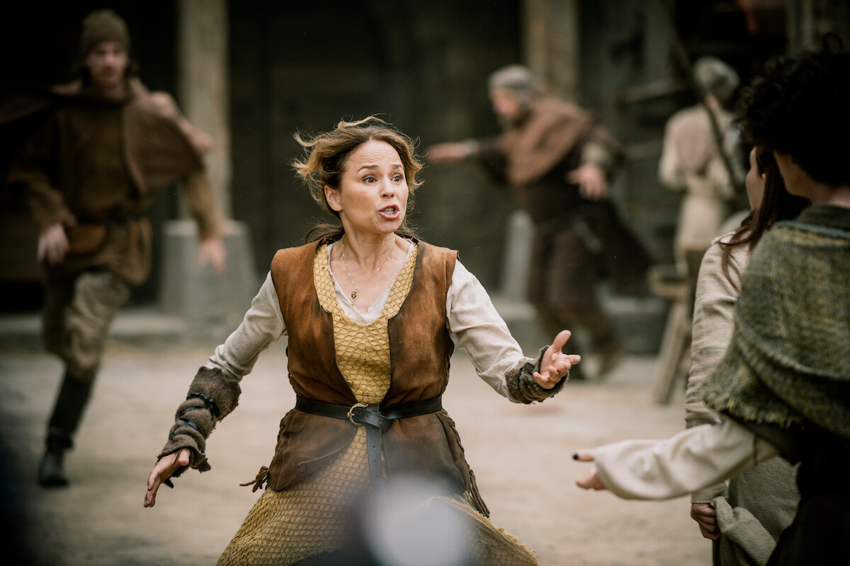 Suzanne Clément as Marie wears a medieval outfit and is surrounded by people running amok in an image from the film ‘Family Pack.’