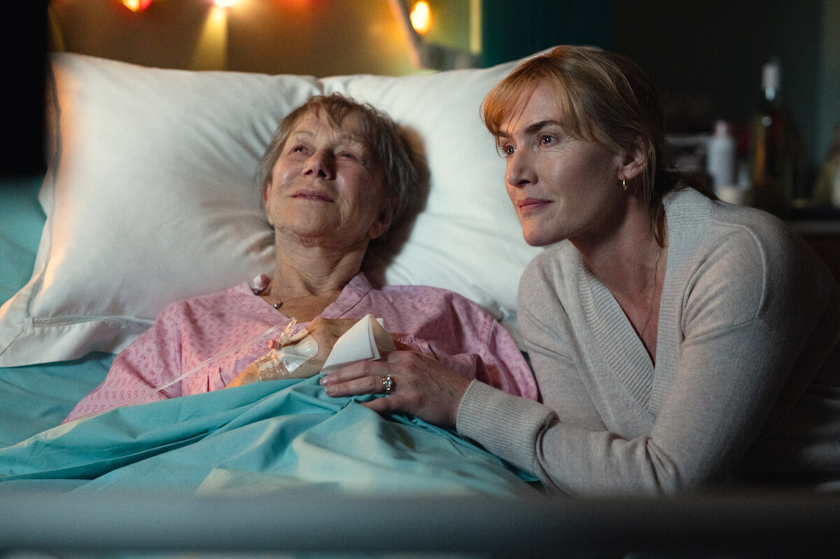 Helen Mirren in a hospital bed and Kate Winslet at her bedside.