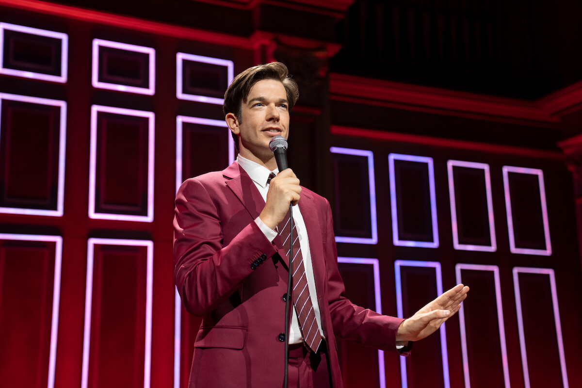 John Mulaney performs on stage.
