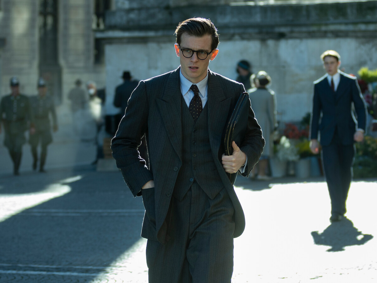 Jannis walking down a street in Munich: The Edge of War