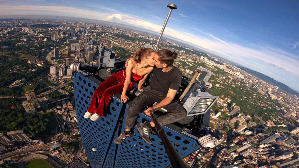 Ivan Beerkus and Angela Nikolau kissing on top of a building