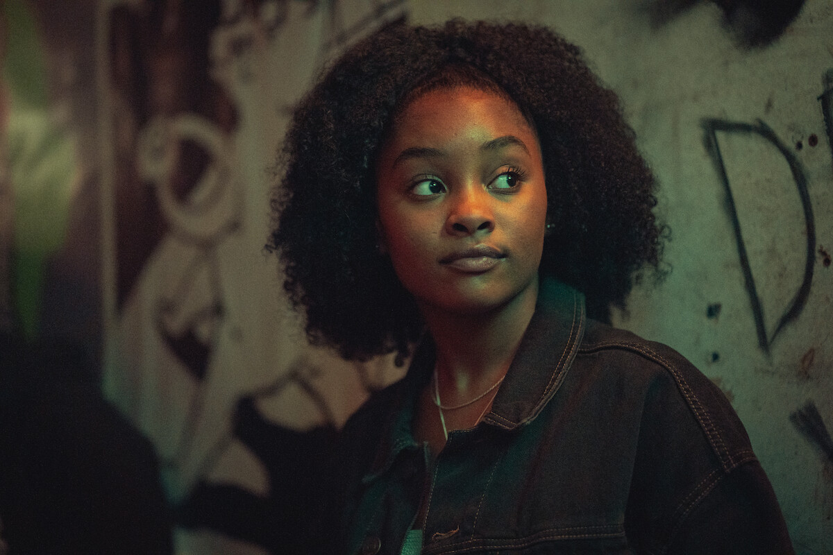 Savanah Graham as Erin stands in front of a graffitied wall in Season 3 of ‘Top Boy.’