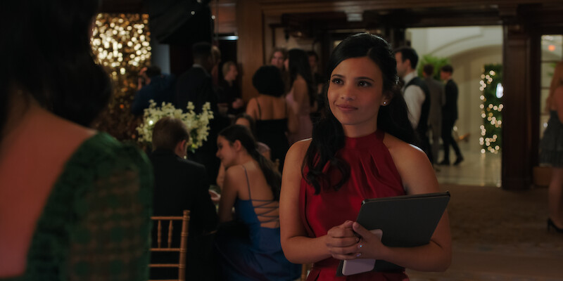 Nikki Rodriguez as Jackie wears a red dress at an event in Season 1 of ‘My Life with the Walter Boys.’