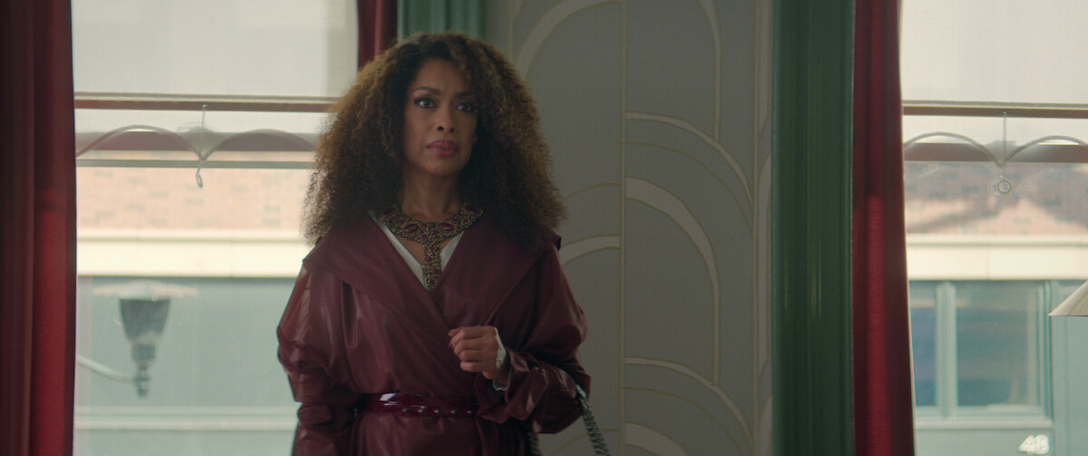Gina Torres wears a garnet-colored coat dress in a still from ‘The Perfect Find.’