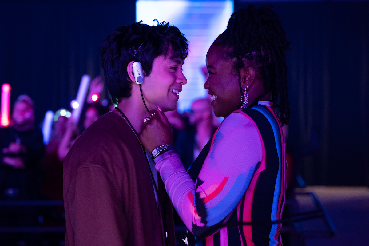 Jordan Mendoza as Felix and Courtney Taylor as Mia embrace and smile in Season 1 of ‘Neon.’