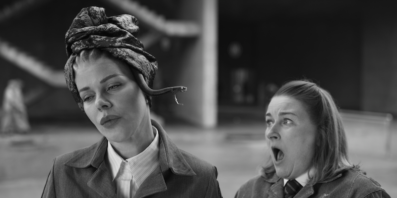 Black and white image of Debi Mazar as Medusa 
with a snake popping out of her headscarf in Season 1 of ‘Kaos’