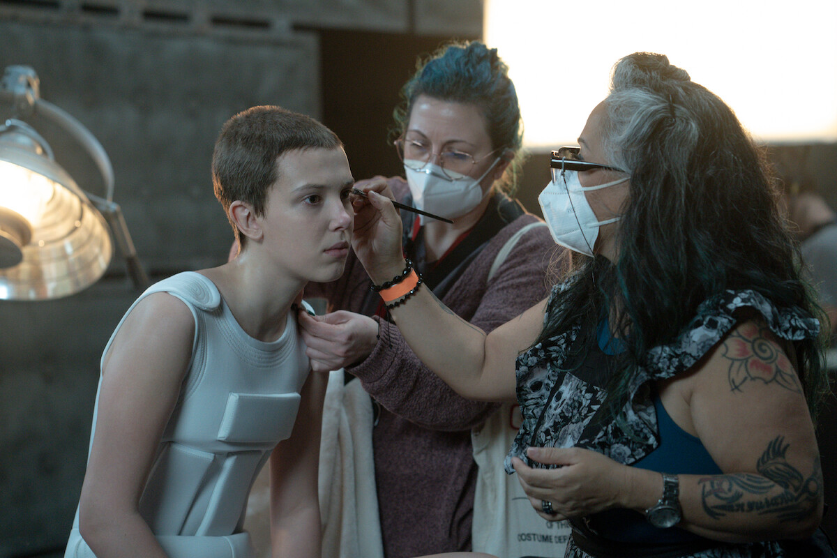 Eleven (Millie Bobby Brown) getting a makeup touchup - The ‘Stranger Things’ Makeup Team Does It All, from Fake Blood to ’80s Eyeshadow
