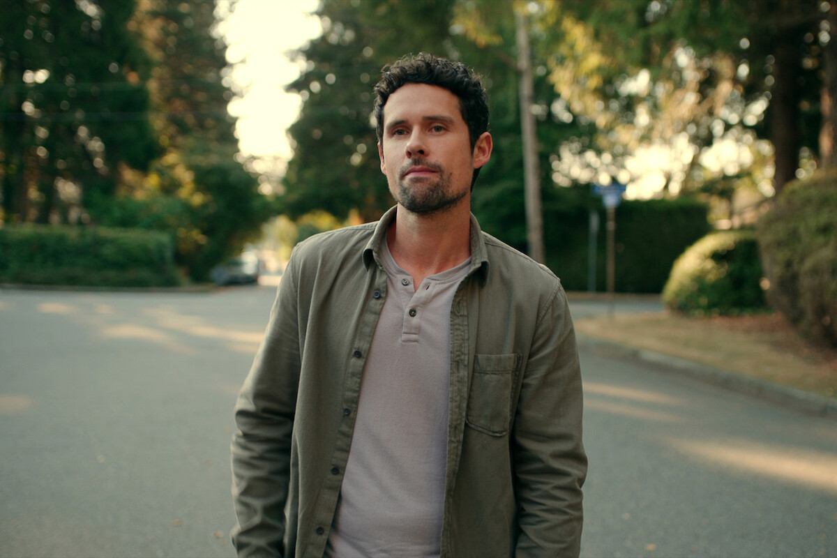 Benjamin Hollingsworth as Dan Brady stands in a street in Season 5 of ‘Virgin River.’
