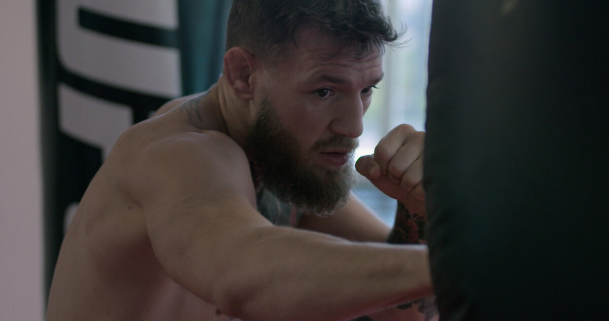Conor McGregor wearing the Irish flag around his shoulders