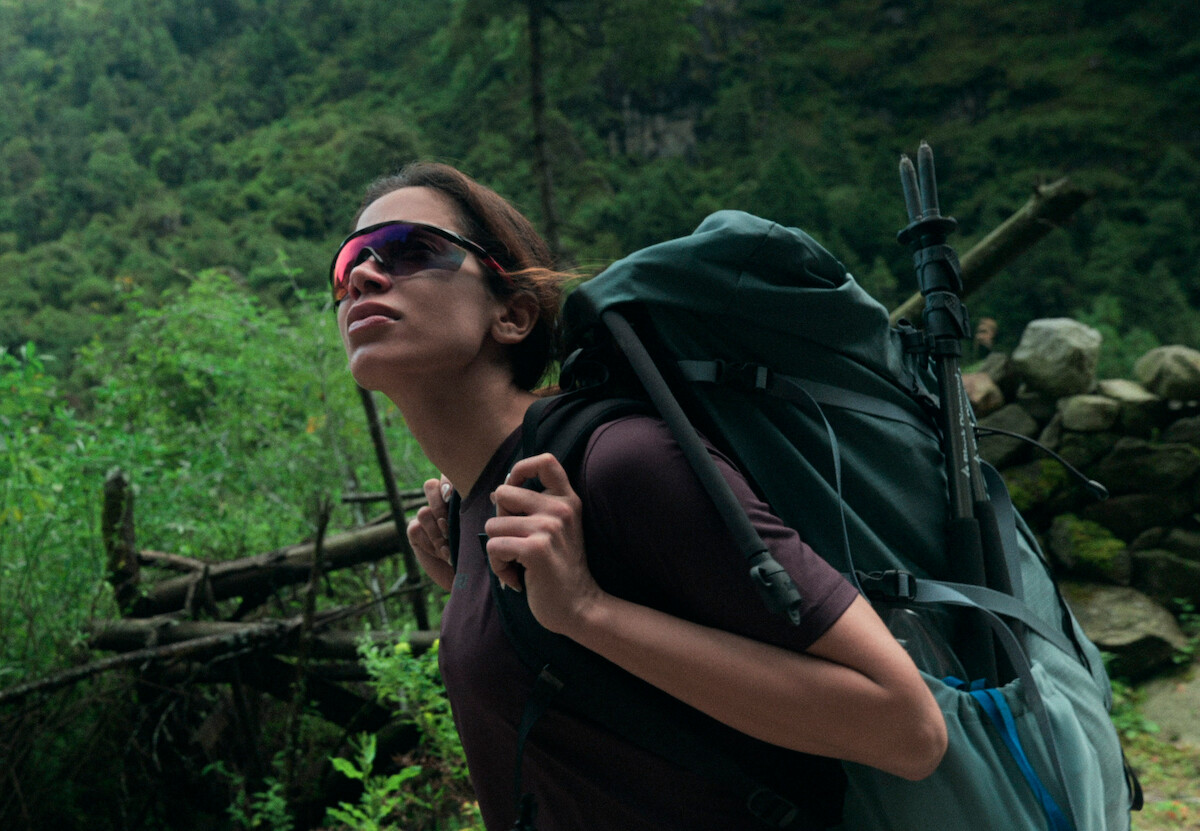 Anitta hiking in the mountains with a backpack