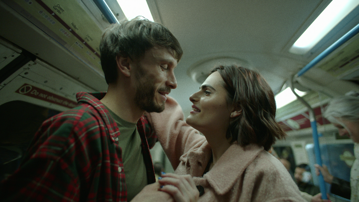 Richard Gadd as Donny Dunn and Nava Mau as Teri smile at each other on a subway in ‘Baby Reindeer.’