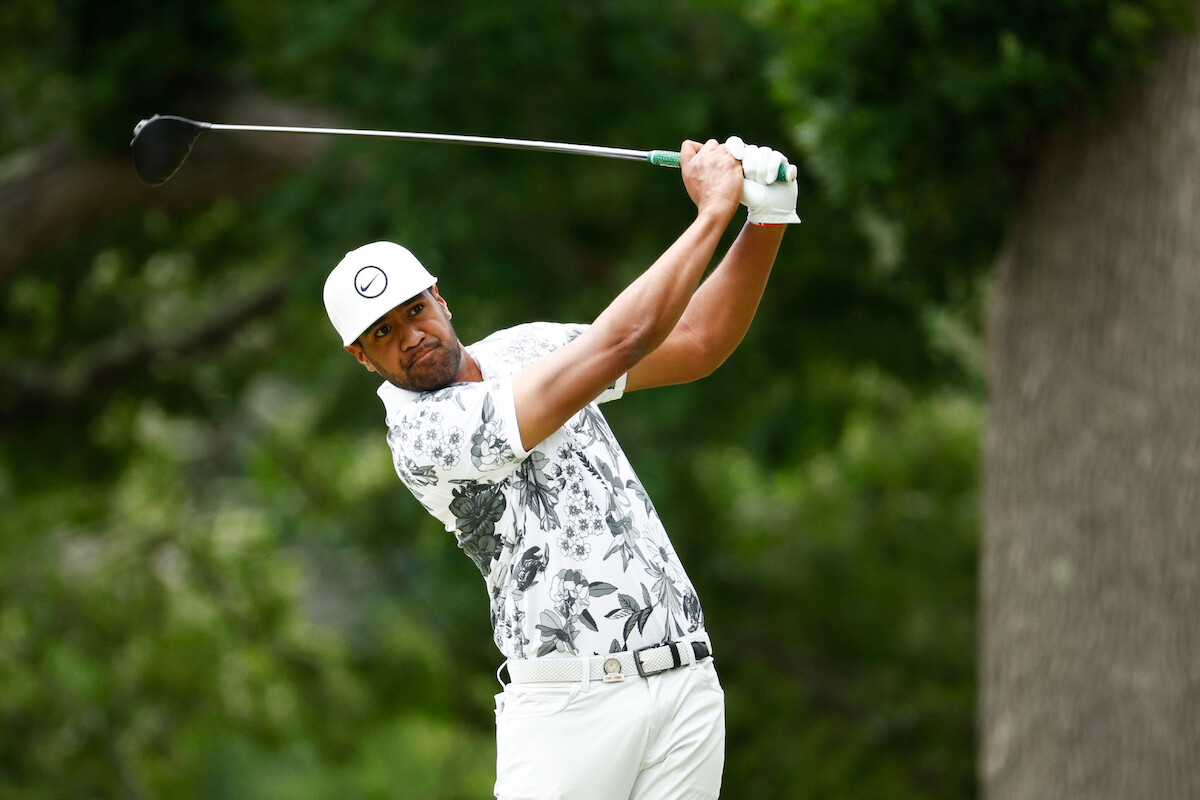 Golfer Tony Finau watches his ball after a drive.