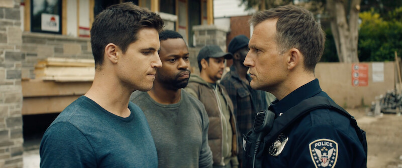Robbie Amell as Connor Reed is challenged by a police officer in 'Code 8'