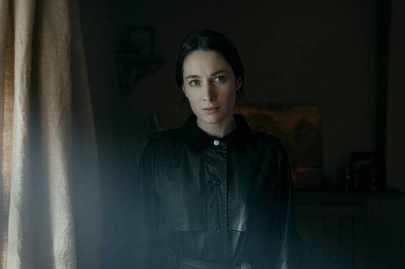 Siobhán Cullen as Dove in stands by a window in 'Bodkin'