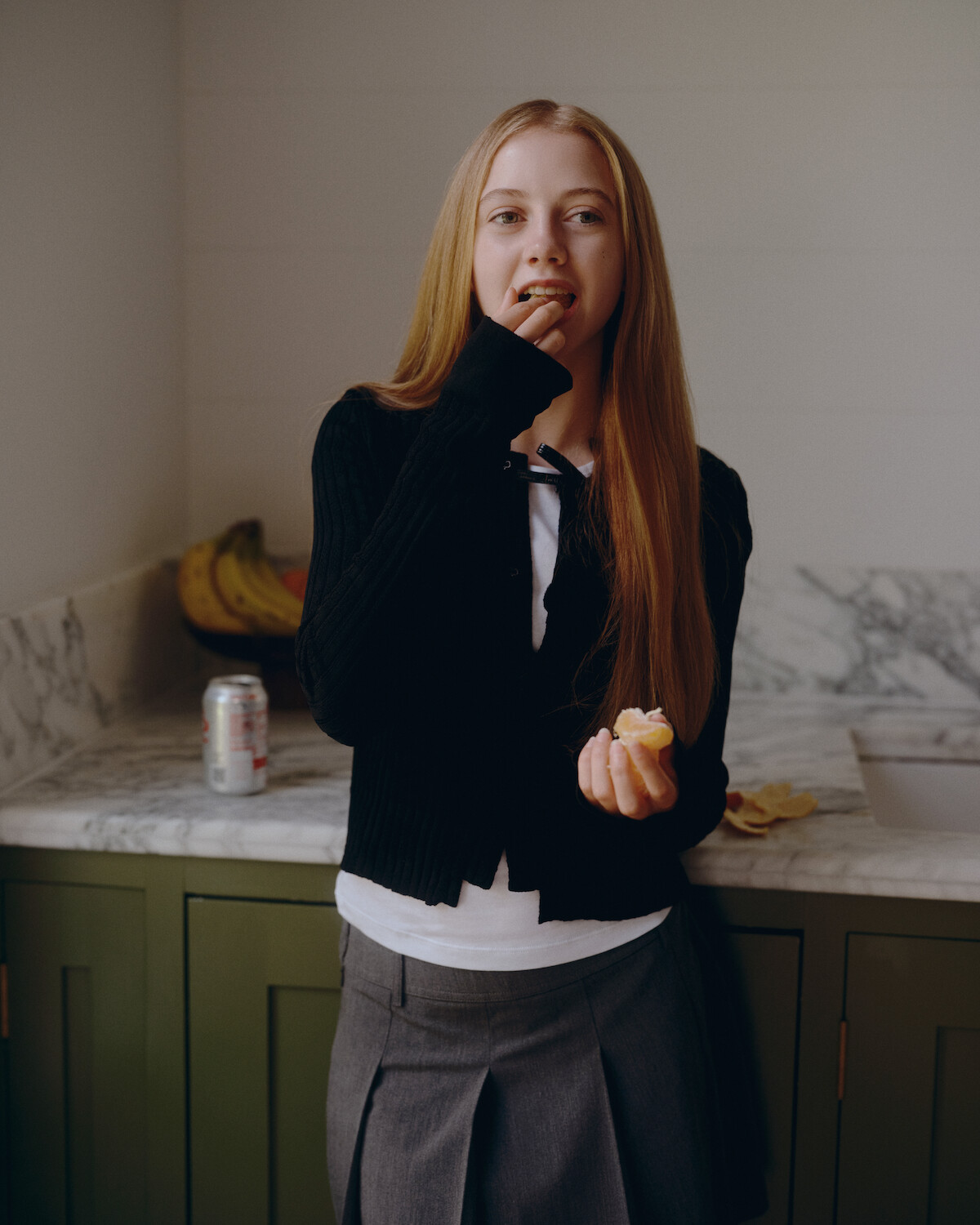 Evie Templeton eating an orange.
