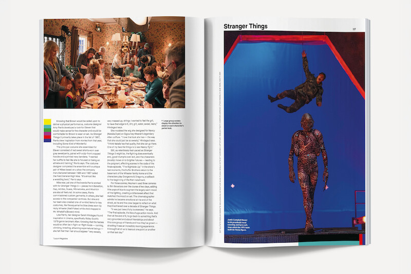 A magazine spread showing people gathered around a dinner table in a cozy, warmly lit room on the left page, and actors on a blue screen set for Stranger Things, with one suspended in air and another in costume, on the right page.