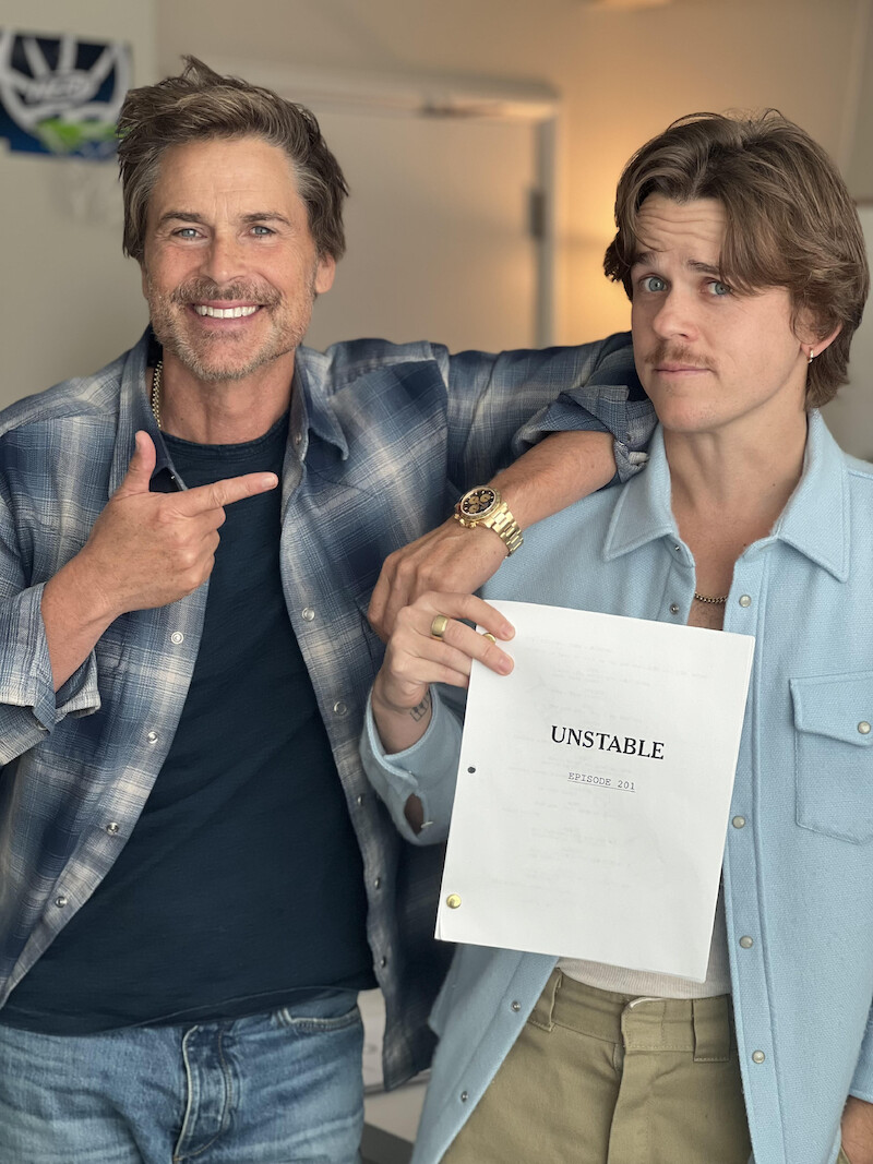 Behind the scenes shot of Rob Lowe and John Owen Lowe holding the script for Season 2 of 'Unstable'
