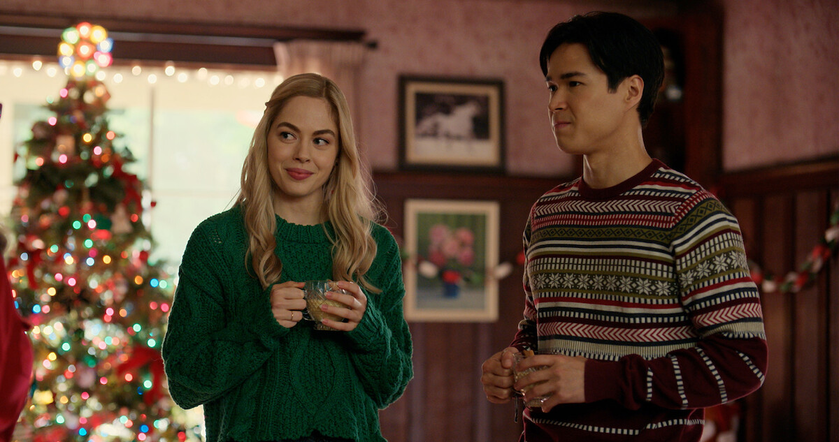 Sarah Dugdale as Lizzie and Kai Bradbury as Denny Cutler gather near a Christmas tree in Season 6 Part 2 of 'Virgin River'