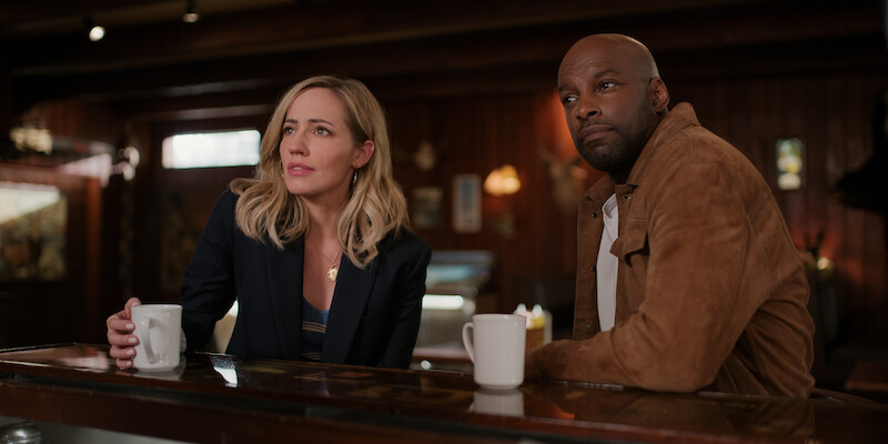 (L to R) Zibby Allen as Brie, Colin Lawrence as Preacher at a bar. 