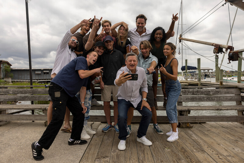Rudy Pankow, Austin North, Madelyn Cline, Charles Esten, Carlacia Grant, Drew Starkey, Jonathan Daviss, Chase Stokes, Director Jonas Pate, Ted Sarandos and Madison Bailey in Outer Banks Season 3 Behind-the-Scenes Photo Gallery