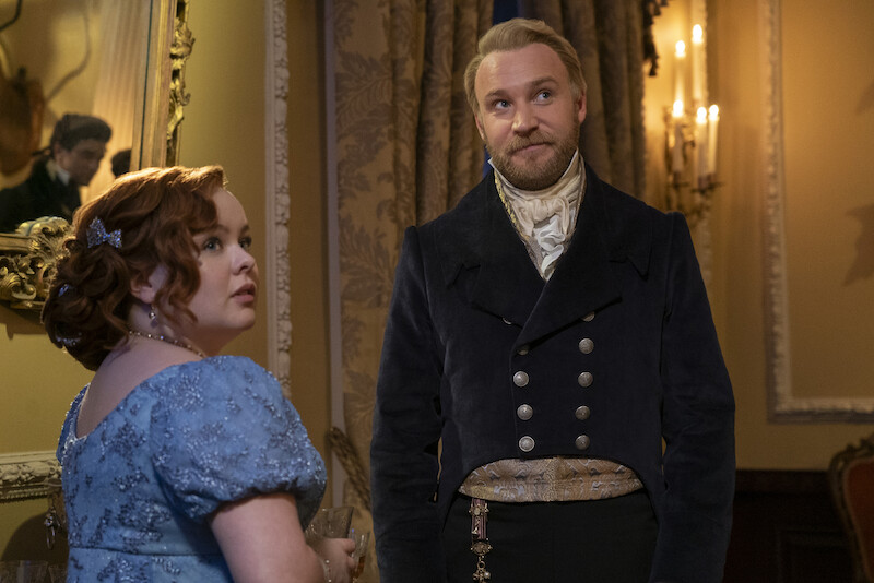 Nicola Coughlan as Penelope Featherington and Sam Phillips as Lord Debling converse together at a ball in season 3 of 'Bridgerton'