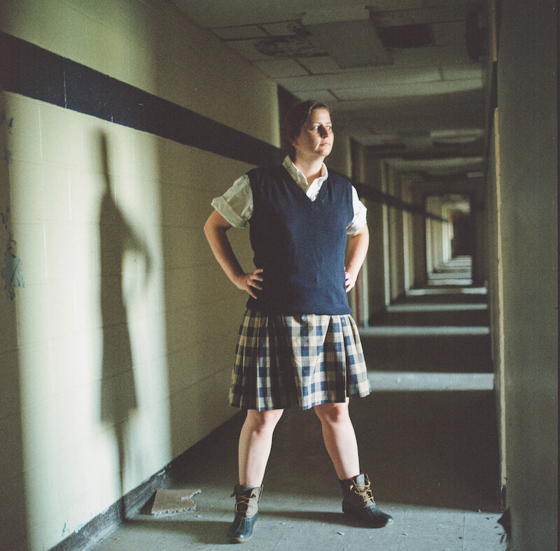 Katherine Kubler standing in the Ivy Ridge hallway in a uniform. 