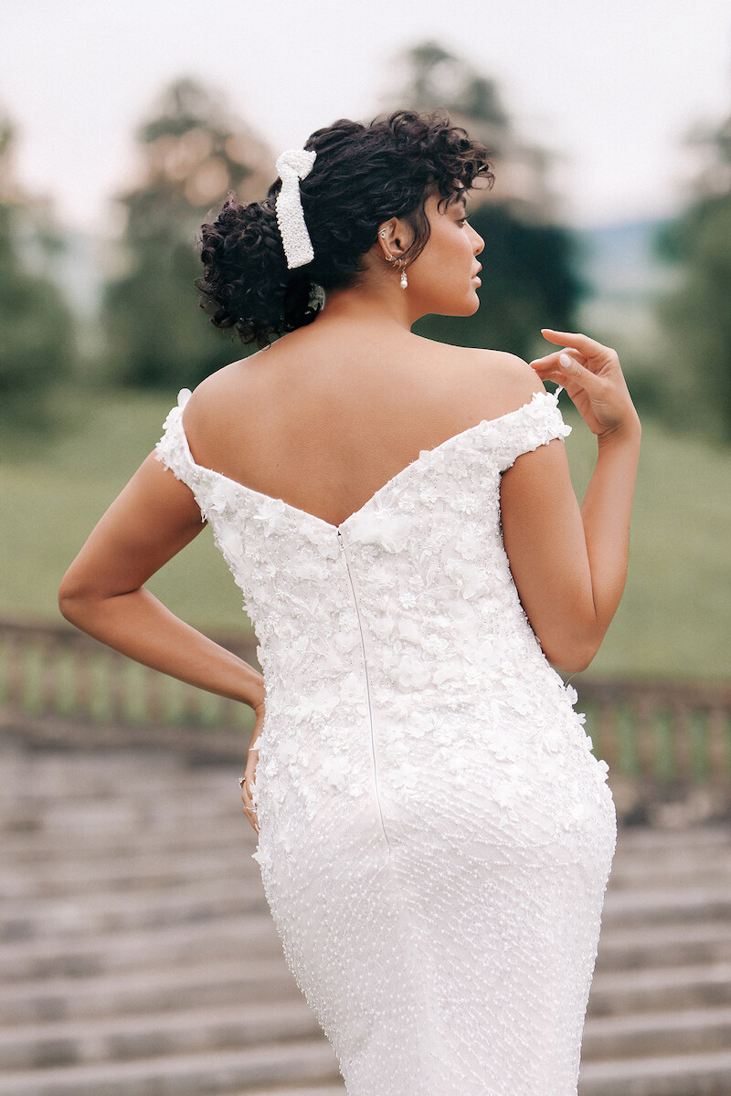 Woman in strapless dress shows off the back of her dress.