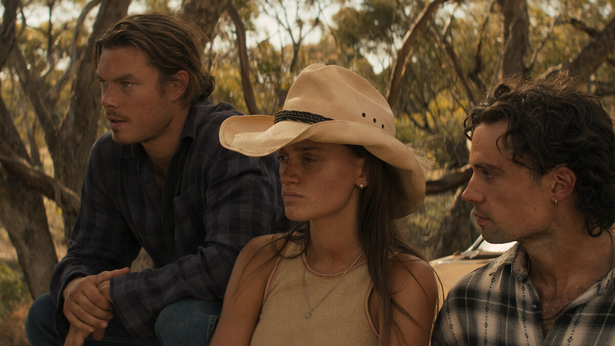 Sam Corlett as Marshall Lawson and Kylah Day as Sharnie Kennedy sit outside together with serious expressions in Season 1 of ‘Territory’