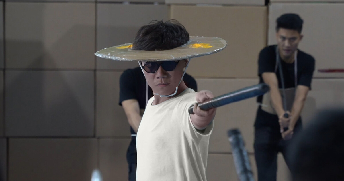 Man with fake sword fighting in behind the scenes footage of 'Blue Eye Samurai.'
