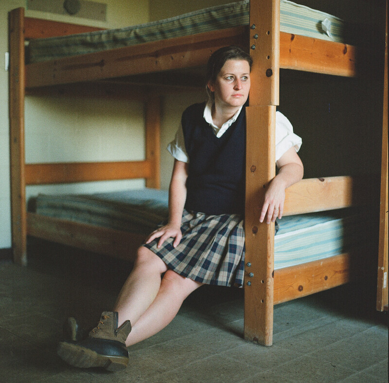 Katherine Kubler sitting on a bunk bed at Ivy Ridge. 