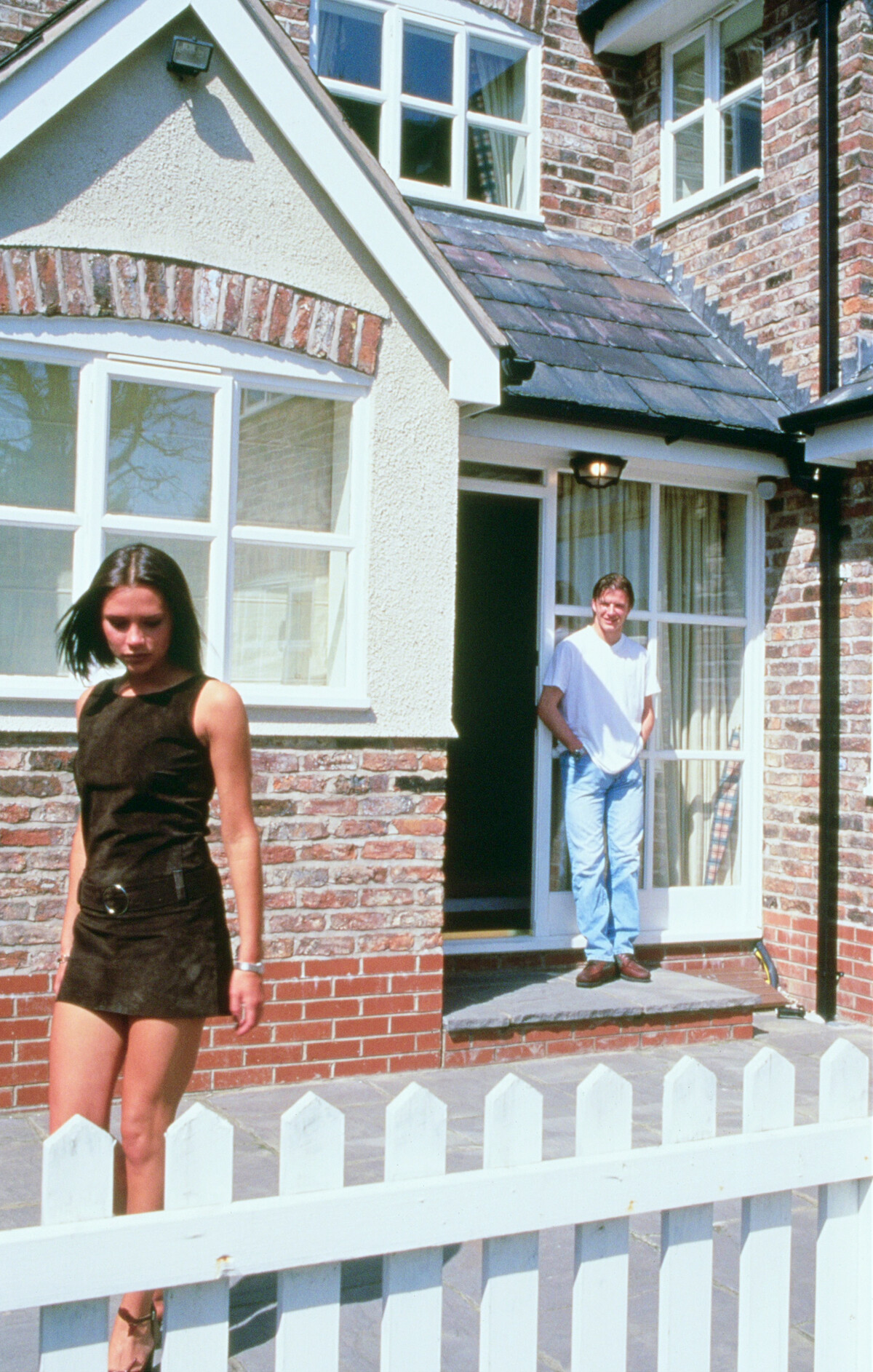Victoria Beckham walks away from David Beckham.