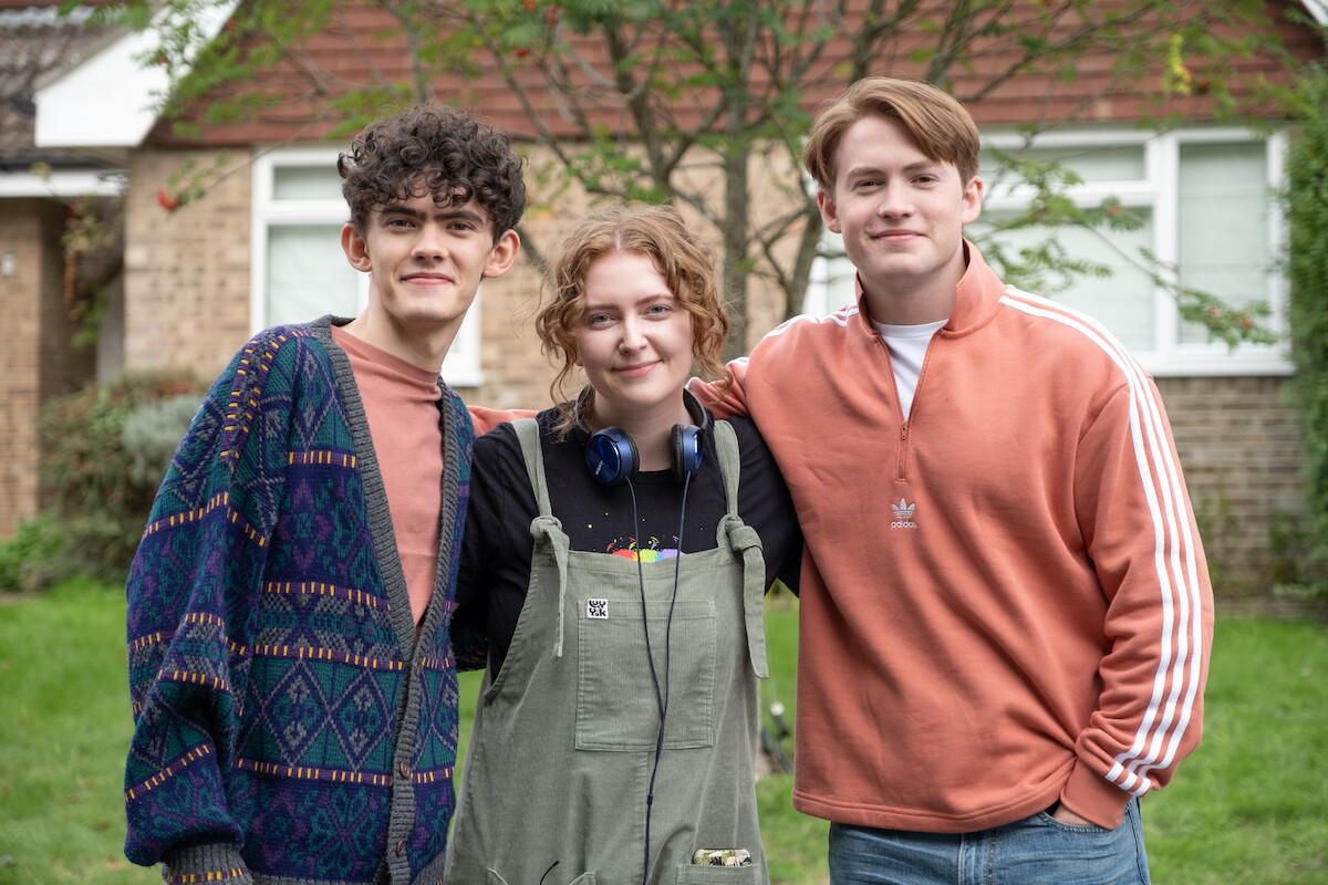 Joe Locke, Alice Osman, and Kit Connor smile together for a portrait during the filming of Season 2 of ‘Heartstopper.’