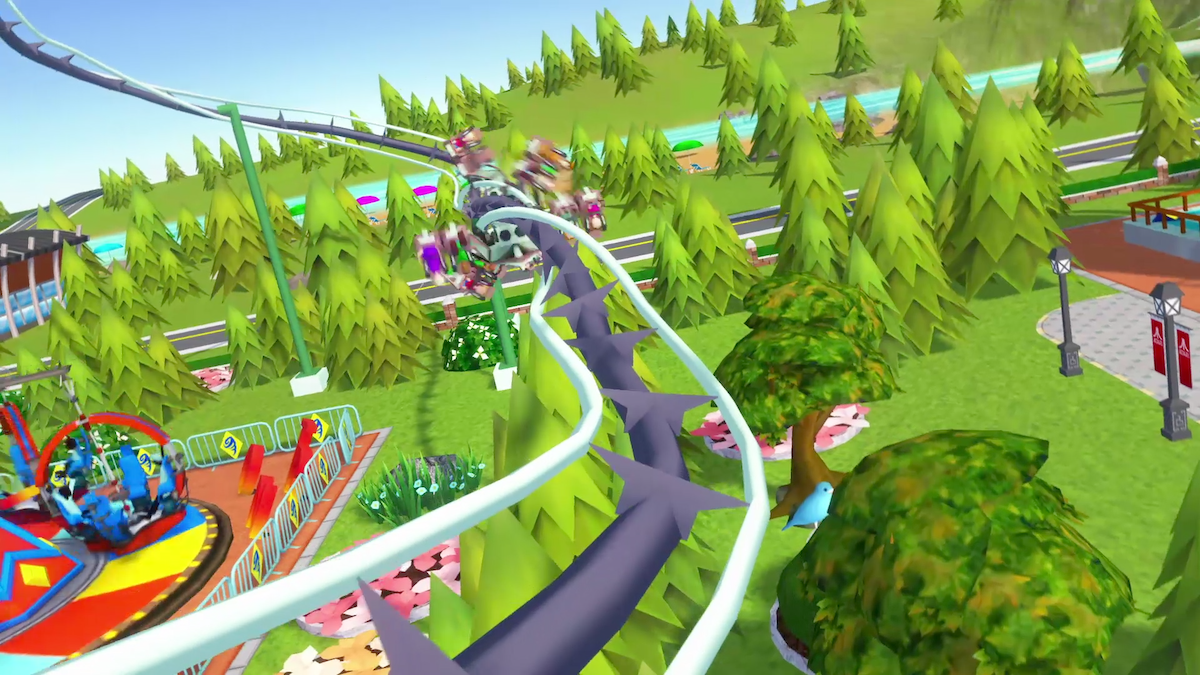 An in-game screenshot from the mobile game ‘Rollercoaster Tycoon Touch,’ featuring a theme park in a forest environment