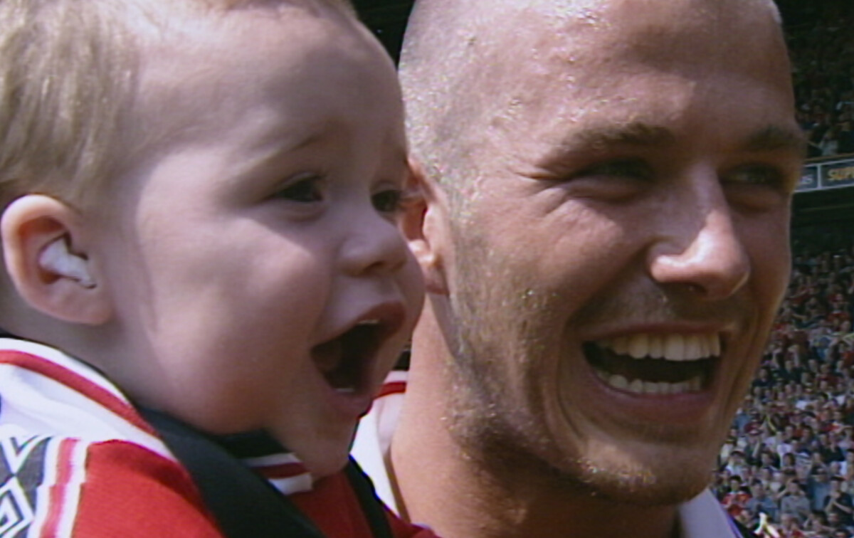 David Beckham holds Brooklyn Beckham.