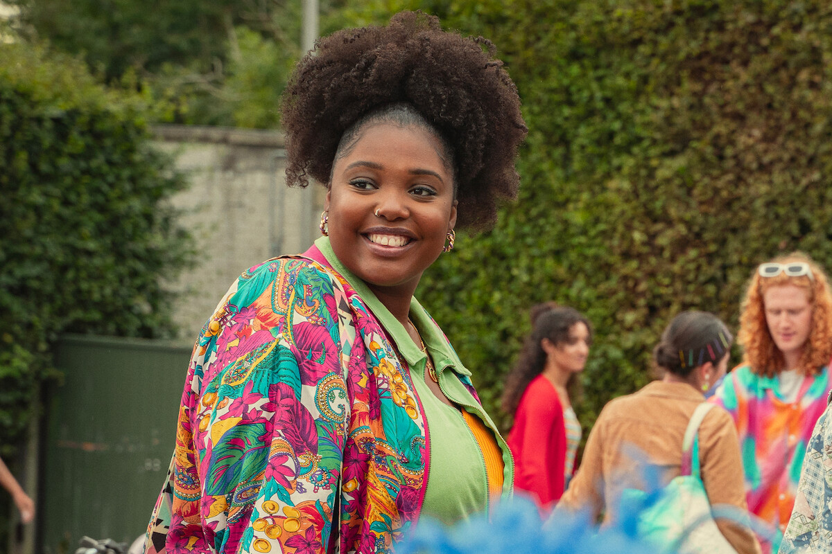 Alexandra James as Aisha smiles in Season 4 of ‘Sex Education.’