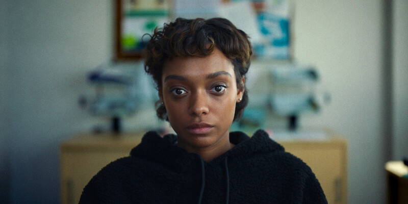 Sophie Wilde as Mia sits in an office in Season 1 of 'Everything Now.'