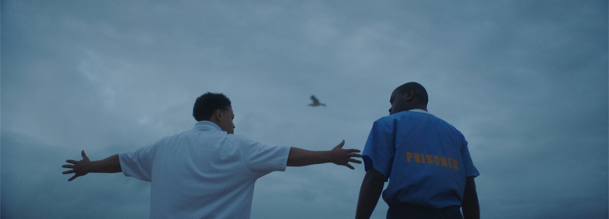 Two young men look at the sky