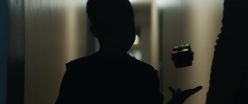 Silhouette of a child throwing a Rubik's cube in 'Code 8'