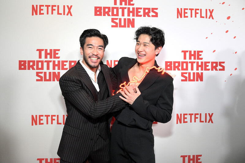 Justin Chien and Sam Song Li smile and embrace at Netflix's 'The Brothers Sun' Los Angeles Premiere at Netflix Tudum Theater 