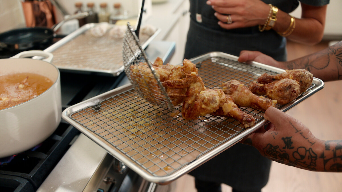Tempura Fried Chicken being placed on a drip tray.