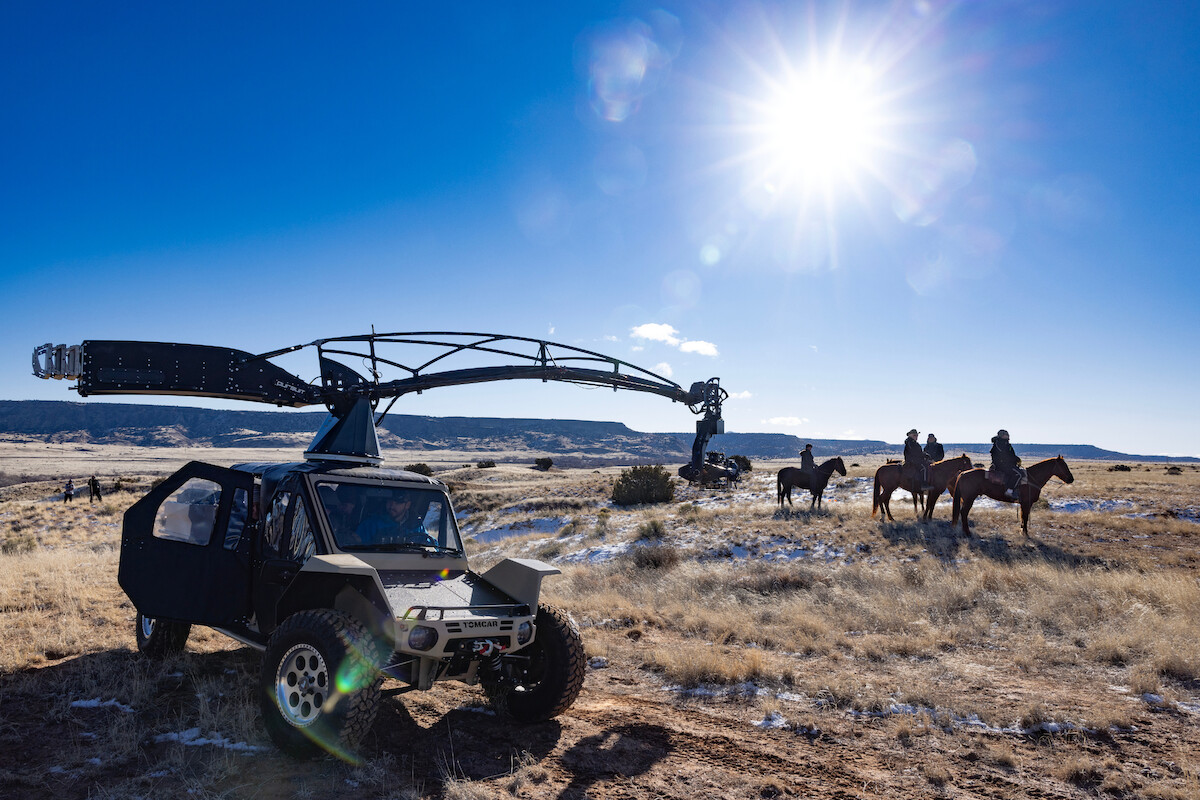 A behind-the-scenes photo with a dune buggy filming a group of cowboys on horses