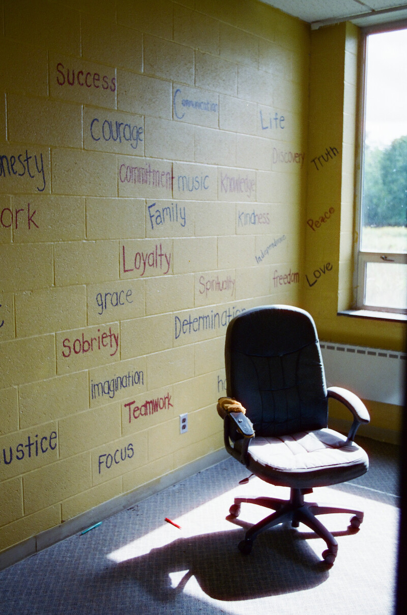 An empty chair in a cinderblock room at The Academy at Ivy Ridge. 