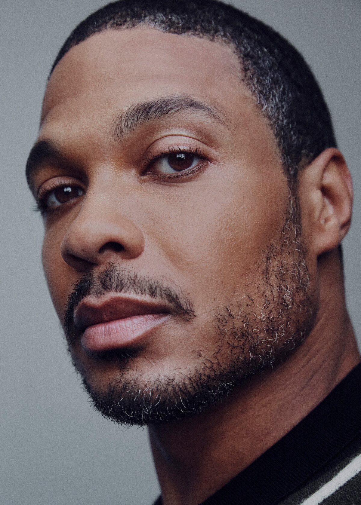Ray Fisher wears a black top.