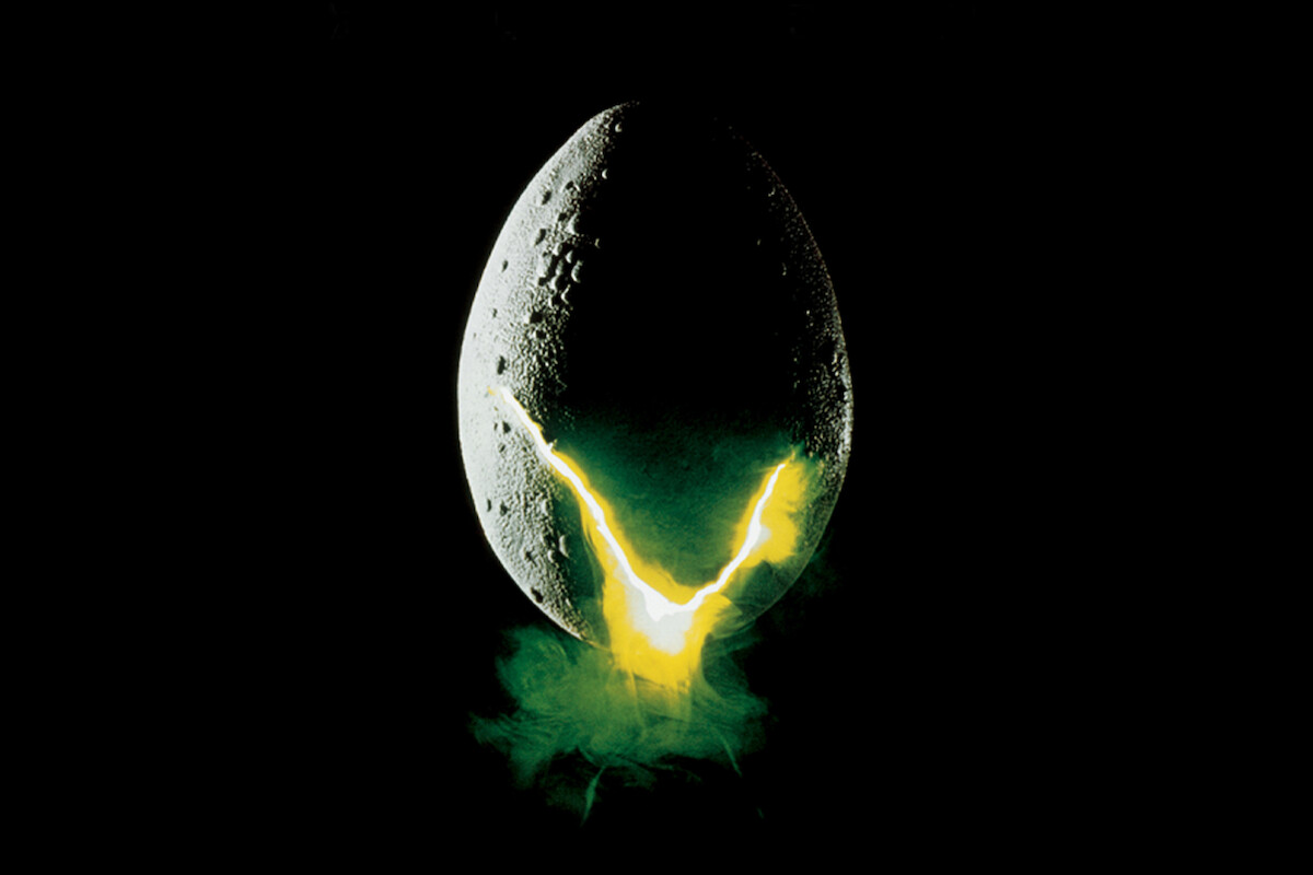 A large, cracked alien egg hovers in darkness, glowing yellow-green light and mist escaping from the crack, suggesting a sci-fi or horror theme in a mysterious and eerie environment.