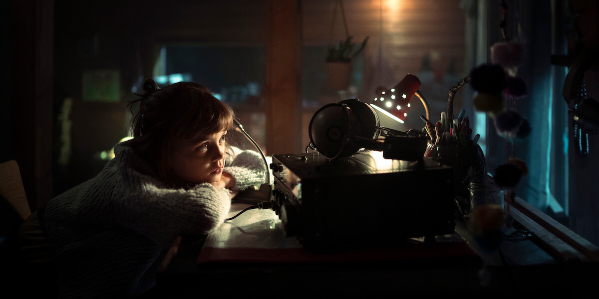 Yuna Bennett as Charlie sits at a desk in a still image from the German series ‘The Signal.’
