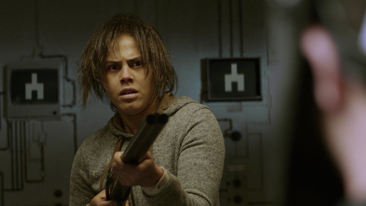 A woman holds a shotgun in Season 2 of 'Black Mirror'