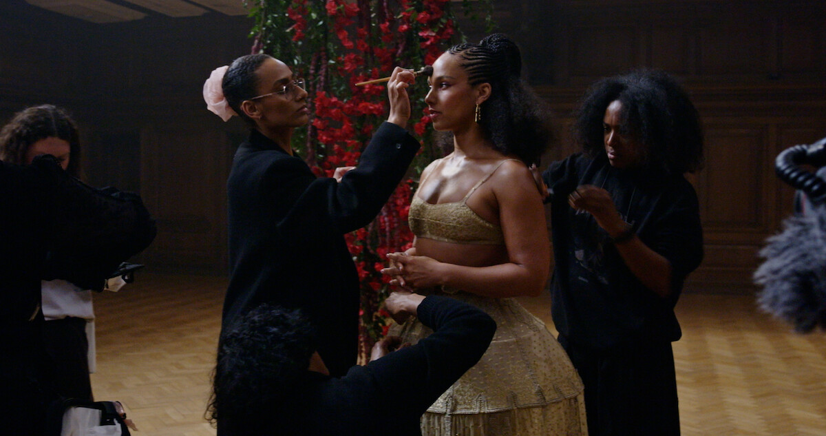 Alicia Keys stands as her makeup is done